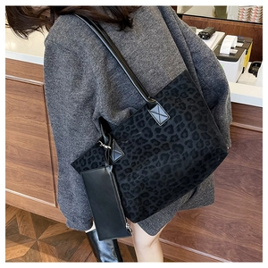 Detail of suede leopard print tote bag with leather strap shown in a daily lifestyle setting