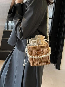 Handcrafted pearl handle woven straw bucket bag with drawstring closure for women