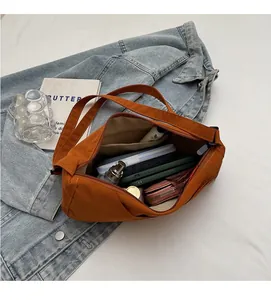 Interior view of large caramel nylon crescent bag showing spacious storage with zipper