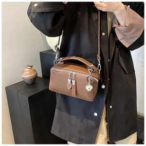 Brown lychee leather boston bag with silver hardware and decorative sphere charm detail
