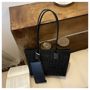 Detail of suede leopard print tote bag showing texture and matching zipper pouch