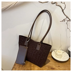 Detailed view of leopard print suede tote bag with matching leather handles and mini pouch