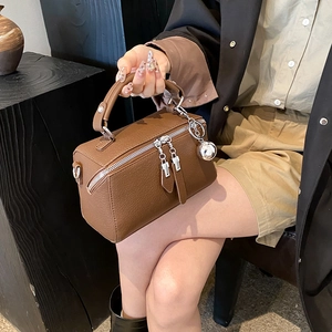 Brown litchi leather Boston handbag with silver zippers and a spherical charm