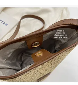 Detail view of woven straw bucket bag showing magnetic closure and herringbone lining