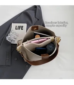 Macro view of large capacity bucket bag showing organized inner compartments and storage
