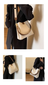 Detail view of cream bucket bag showing wide fabric shoulder strap and high quality PU leather