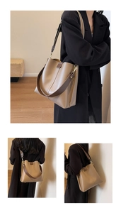 Detail of minimalist khaki bucket bag with vertical stitching and wide shoulder strap style