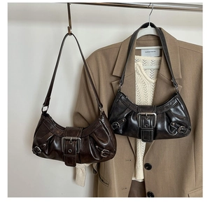 Detail of vintage Y2K hobo bags in caramel brown and distressed black with metal buckles