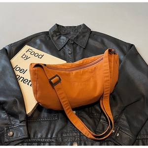Macro shot of dark orange crescent bag texture on black leather jacket background