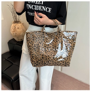 Détail du sac cabas léopard avec logo blanc et texture imperméable haut de gamme