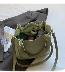 Spacious interior of light green bucket bag showing large capacity for daily items