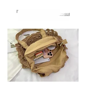 Detail view of woven straw beach bag showing interior zipper pocket and spacious capacity
