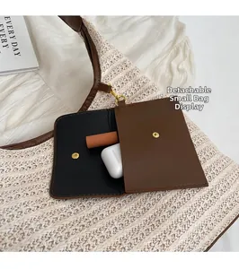 Detail of detachable leather pouch on straw tote bag for small item storage and utility