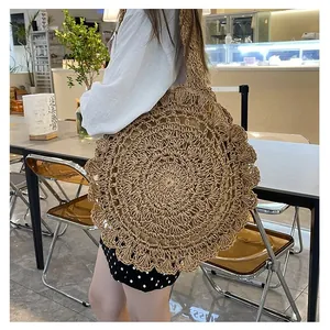 Detail showing the intricate crochet weave and wavy scalloped edges of the round straw bag