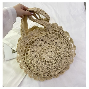 Handmade beige woven straw tote bag with elegant lace-style crochet edges and handles