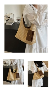 Detail of a large straw tote bag with brown straps and side pouch on a white lace dress
