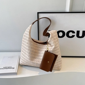 Stylish large straw tote bag with brown leather straps and matching hanging pouch