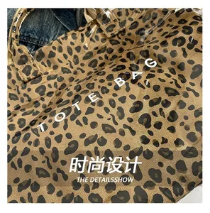 Détail du sac cabas léopard avec revêtement PVC transparent et texte blanc TOTE BAG