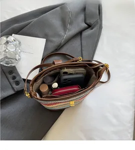 Interior view of the striped woven bucket bag showing large capacity for essentials
