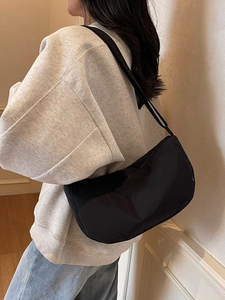 Minimalist black nylon crescent shoulder bag for daily commuting and casual styling