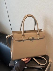 Elegant grey Saffiano trapezoid handbag with gold twist lock and adjustable strap