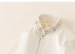Detail of Chinese style velvet shirt featuring mandarin collar and pearl button embroidery