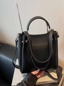 Classic black leather bucket bag with top handle and adjustable gold-tone shoulder strap