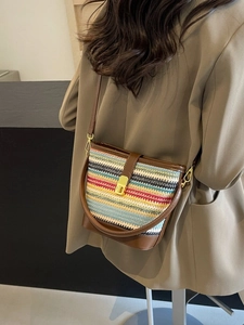 Retro multi-colored woven bucket bag with brown leather trim and golden metal lock