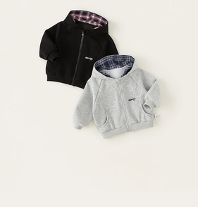 Detailed view of children's cotton zip-up hoodies with plaid lining and Adventure embroidery