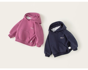 Detailed flat lay of rose red and navy hoodies showing fleece texture and kangaroo pockets