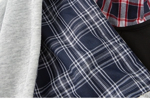 Macro detail of the multilayered interior lining with various plaid patterns and knit fabric