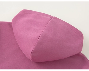 Detailed close-up of vibrant magenta hoodie fabric texture and precision stitching