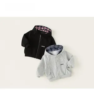 Detailed close-up of hooded sweatshirts with plaid lining and letter print design
