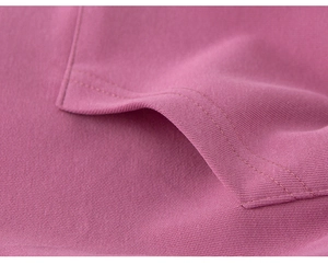 Detailed close-up showing the fine double-needle stitching on the pink cotton hoodie pocket