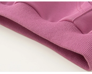 Detailed macro view of the purple ribbed cuffs on this soft cotton children's hoodie