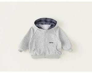 Close-up of kids gray hooded sweatshirt featuring blue plaid lining and embroidery