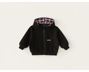 Close-up of boys black hoodie with red-blue plaid hood lining and adventure embroidery