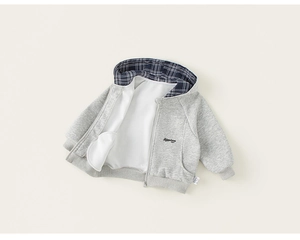 Detail of gray kids hoodie showing checkered hood lining and fine embroidery
