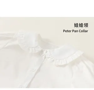 Close-up of white girls' blouse featuring a sweet Peter Pan collar and ruffle edges