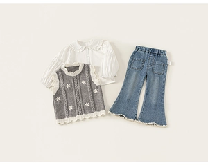 Detailed view of girls floral knit vest, ruffled collar shirt and flared denim pants