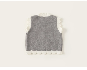 Detailed knit texture of grey girls' vest with white scalloped trim and hollow wave patterns