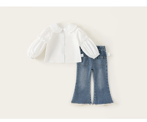 Detail of girls' white shirt with Peter Pan collar and denim flares with lace trim