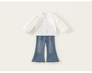 Detail of white cotton blouse with ruffle collar and flared denim pants with lace trim