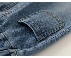 Detailed macro view of denim pocket with yellow double stitching and washed texture