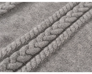 Close-up of the grey cable knit texture and soft material on girl's spring outfit