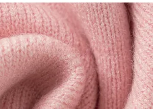 Close-up of soft pink knit fabric showing detailed fluffy texture and wavy pattern