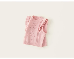 Detail of pink knit vest featuring ruffled shoulders and diamond pattern hollow knitting