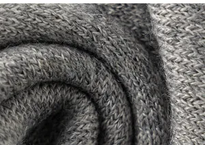 Detailed macro view of the grey knitted fabric texture on the girls preppy school vest