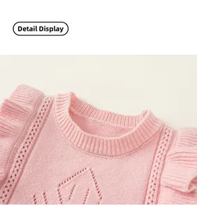 Detail of pink knit vest with ruffled shoulders and delicate openwork diamond patterns