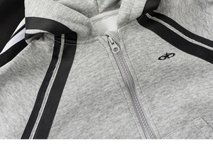 Close-up of grey zip-up hoodie featuring black stripe trim and embroidered star logo
